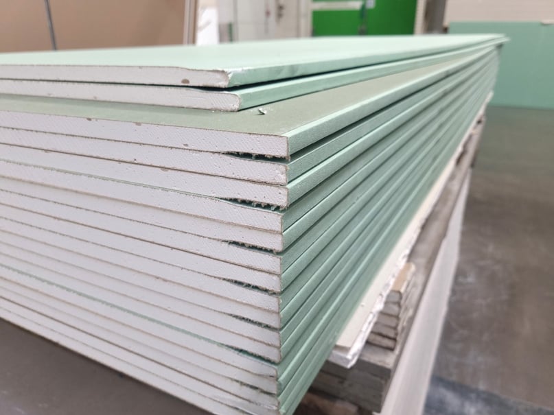 water resistant plasterboard sheets stacked in a hardware store.